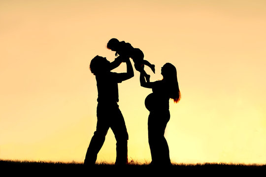 Silhouette of Happy Family Celebrating Pregnancy