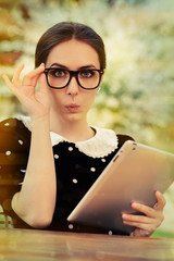 Surprised Young Woman with Glasses and Tablet