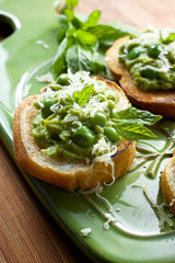 Canape with green peas pesto, cheese and fresh mint