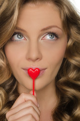 Woman looking up and holding a heart