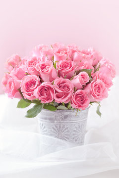 many beautiful fresh pink roses on a table.