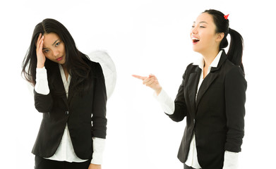 Devil side of a young Asian businesswoman laughing on angel side