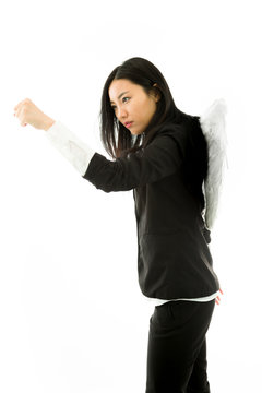 Asian young businesswoman dressed up as an angel punching with