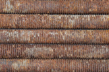 Long rusted bolts as background