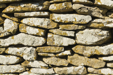 Dry stone limestone wall, small stones, texture, pattern backgro