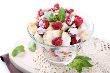 Fruit salad in glass bowl, isolated on white