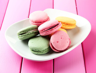 Gentle macaroons on plate on table close-up