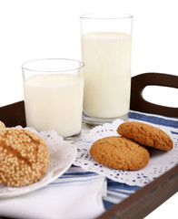 Milk and cookies on wooden tray isolated on white