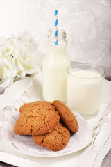 Milk and cookies on table on grey background
