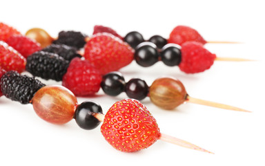 Fresh berry kebabs for healthy snack isolated on white