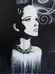 graffiti on a wall with a thoughtful woman © yournameonstones