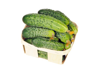 pile of cucumber in a veneer basket isolated