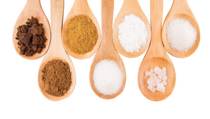 Various type of sugar on wooden spoon over white background