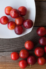 Plums on a wooden board and plate