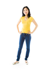 Young Asian woman standing with her arms akimbo