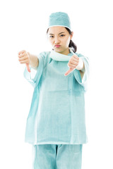 Unhappy Asian female surgeon giving thumbs down gesture