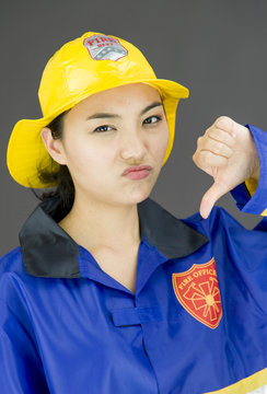Lady firefighter showing thumbs down sign