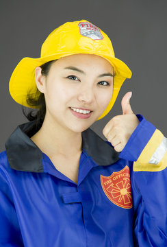 Close up of a lady firefighter showing thumbs up gesture