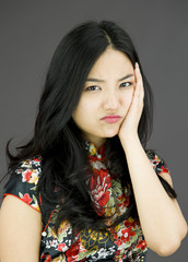 Asian young woman looking bored