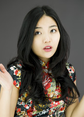Asian young woman don't know what to do isolated on colored