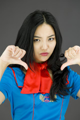 Unhappy Asian air stewardess giving thumbs down gesture