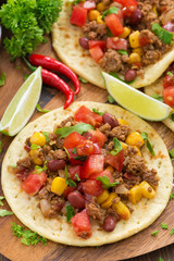 tortillas with chili con carne and tomato salsa