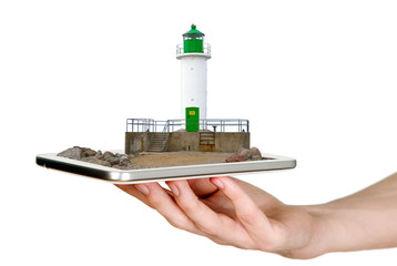Man is showing white lighthouse with green details