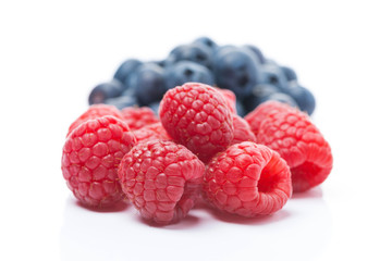 raspberries and blueberries, selective focus, isolated