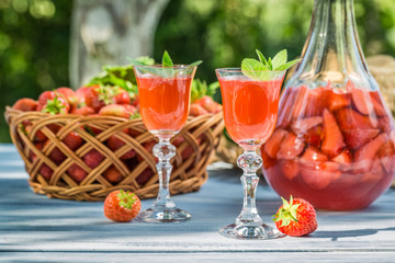 Homemade strawberry liqueur served in the garden