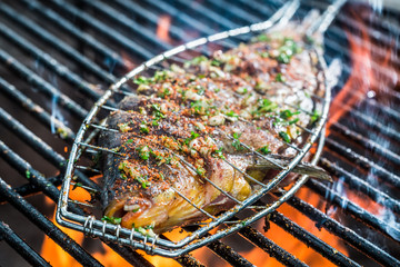 Baked fish on the grill with fire