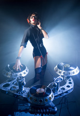 DJ girl playing in a club on vinyl