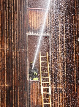 brave Firefighter in action delivers plenty of water while shutt