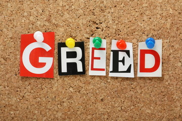 The word Greed on a cork notice board