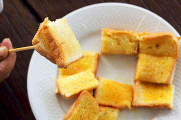 Toast with butter and sprinkling with sugar.