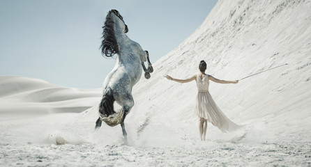 Pretty lady with huge horse on the desert - obrazy, fototapety, plakaty