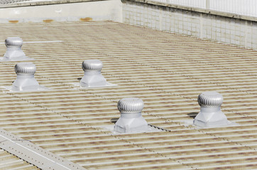 Fototapeta na wymiar Roof of factory with roof ventilators in sunshine day