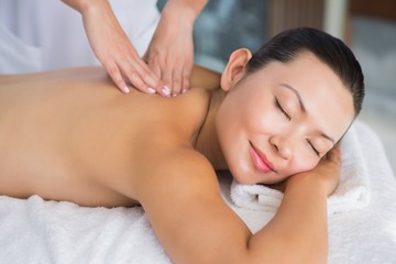 Fototapeta na wymiar Content brunette getting a back massage