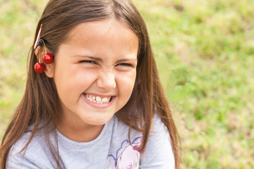 cute little girl with two cherries in hair