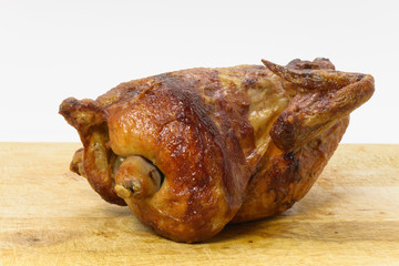 Whole roast chicken on a chopping block