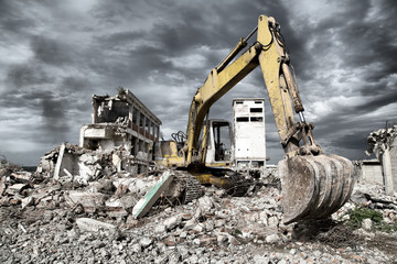 Bulldozer removes the debris from demolition of old buildings - obrazy, fototapety, plakaty