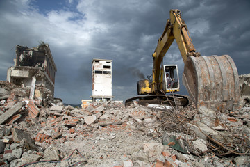 Bulldozer removes the debris from demolition of old buildings