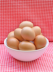 eggs in the bowl on  red background.