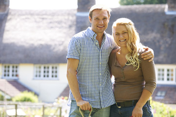 Portrait Of Couple Working In Garden Together