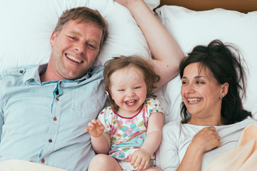 Fototapeta premium Happy family in bed