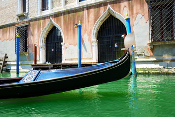 Fototapeta na wymiar The gondola is on water channel, Venice, Italy