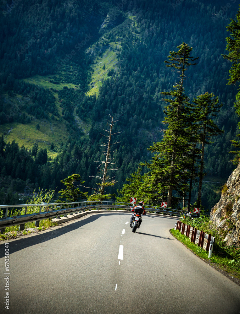 Fototapete Motorcyclist on mountainous road