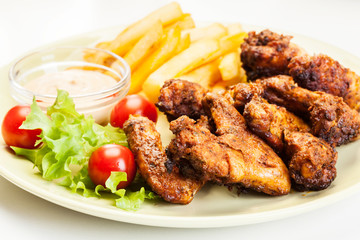 Chicken wings with fries french and spicy sauce