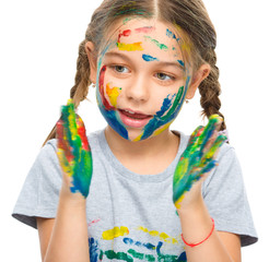 Portrait of a cute girl playing with paints