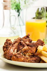 Chicken wings with fries french and spicy sauce