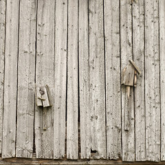 two old broken homemade birdhouses